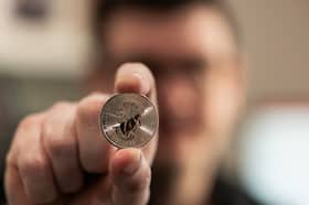 A silver coin exclusively minted for Augusta Precious Metals, where whistleblower Dale Whitaker was chief financial officer until 2017, photographed at his home office in Spokane, Wash. (Rajah Bose for The Washington Post)