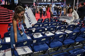 Pages place Trump posters on delegates' seats at the Republican National Convention on July 16. (Ricky Carioti/The Washington Post)