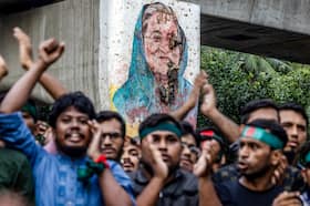 Students chant slogans near a vandalized mural of Bangladesh’s ousted prime minister, Sheikh Hasina, during a protest on Monday in Dhaka.