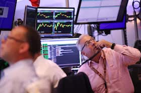 Traders work on the floor of the New York Stock Exchange on Aug. 6. (Michael M. Santiago/Getty Images)