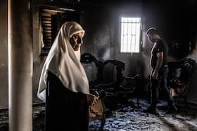 Moawieh Sadah walks through a home that was burned and vandalized by Jewish settlers in Jit.