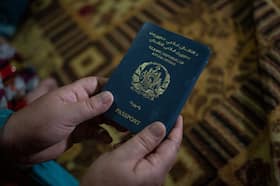 A woman holds an Afghan passport in Islamabad, Pakistan, in 2023.