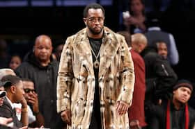 Sean “Diddy” Combs, wearing a fur coat, attends a basketball game in 2017.