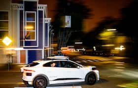 A passenger yells out the window of his self-driving taxi as it takes him to his destination in San Francisco on July 11.