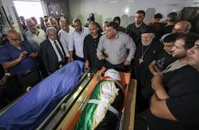 Nablus Governor Ghassan Daghlas speaks in front of the bodies of Turkish American Aysenur Eygi and 13-year-old Palestinian Bana Laboum at a hospital morgue in Nablus in the occupied West Bank on Saturday.