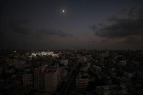 Al-Shifa Hospital complex is lit up against the darkness of Gaza City on Oct. 24 amid severe fuel shortages in the Gaza Strip.