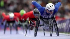 Daniel Romanchuk races on his wheelchair, with other competitors behind him.