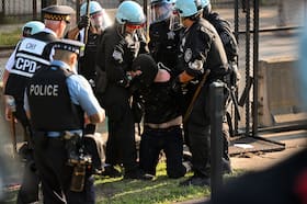 A demonstrator is arrested during a protest near the United Center in Chicago on Monday. (Joshua Lott/The Washington Post)