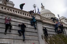 Supporters of President Donald Trump are seen scaling the walls at the U.S. Capitol on Jan. 6, 2021. (Michael Robinson Chávez/The Washington Post)