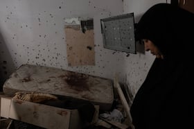 Hureen Zandiq Jaber, 62, stands near a bloodstained mattress in her brother's home in the camp.